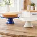 Cobalt speckled enamel cake stand with a sponge, ivory stand beside
