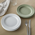 White and sage speckled enamel dinner plates stacked in pairs
