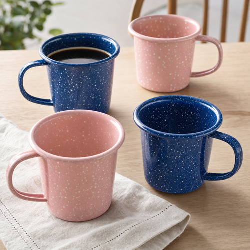 Cobalt and blush speckled enamel mugs on a table