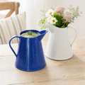 Cobalt speckled enamel pitcher with water, white pitcher with flowers