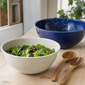Ivory speckled enamel salad bowl with a cobalt bowl behind